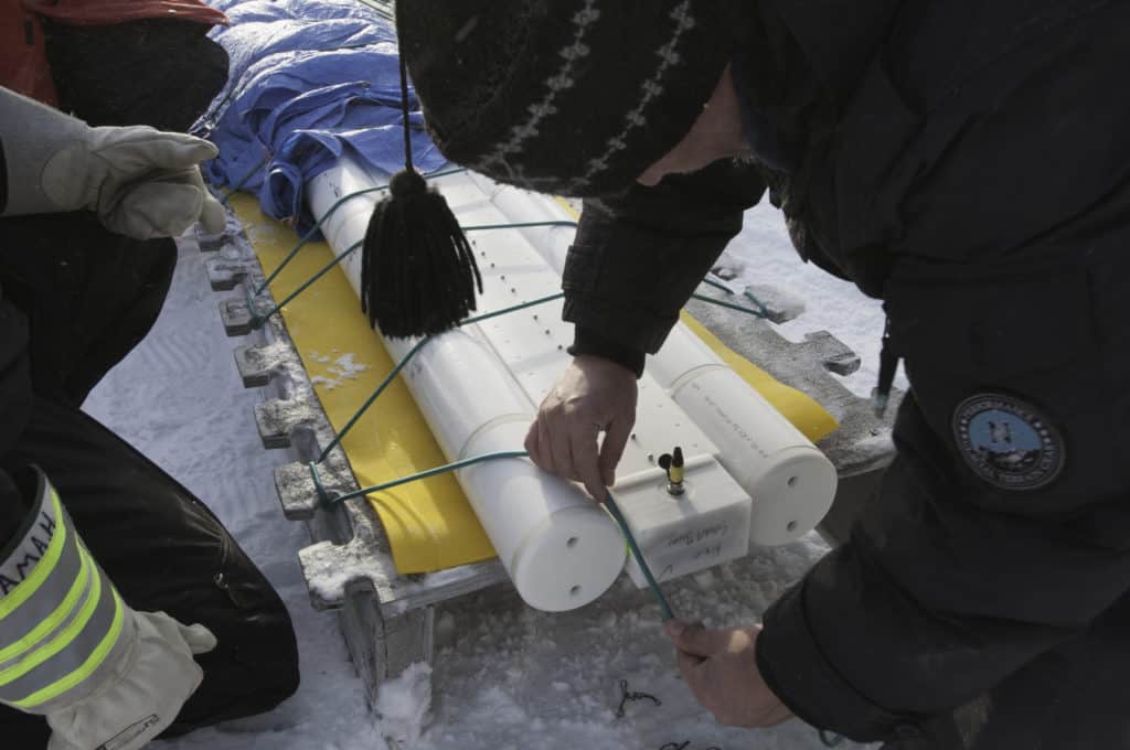 Rex Holwell lashes SmartBuoy onto kamautik.