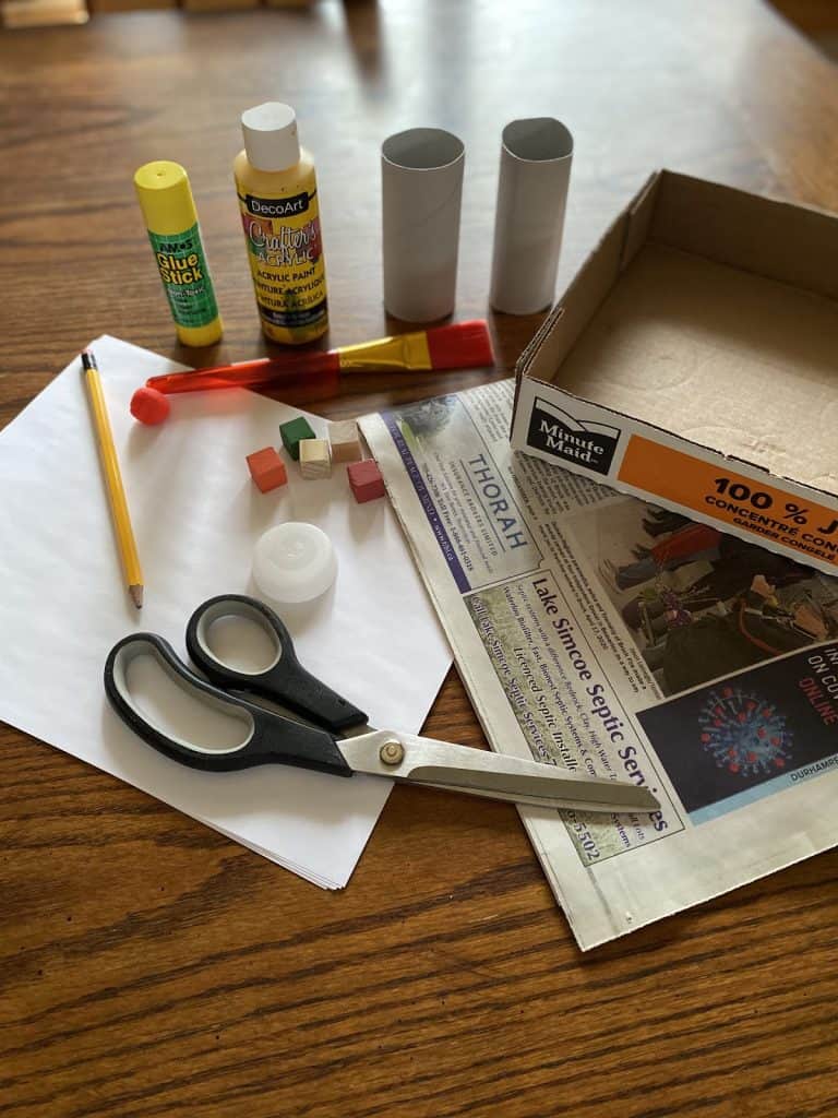 Recycled marble maze activity materials.