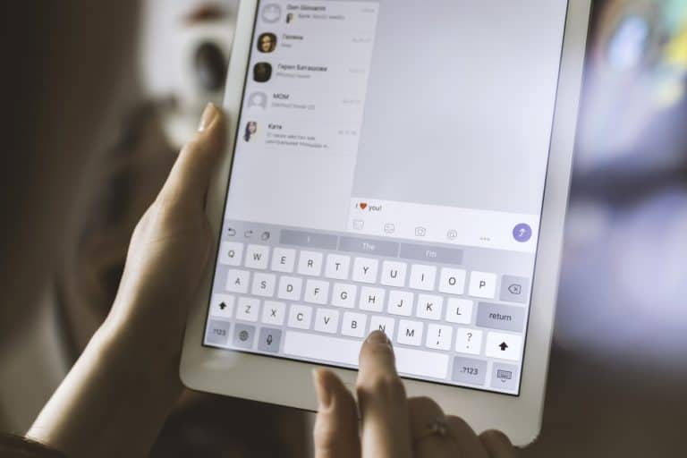 A person typing a message using a tablet.