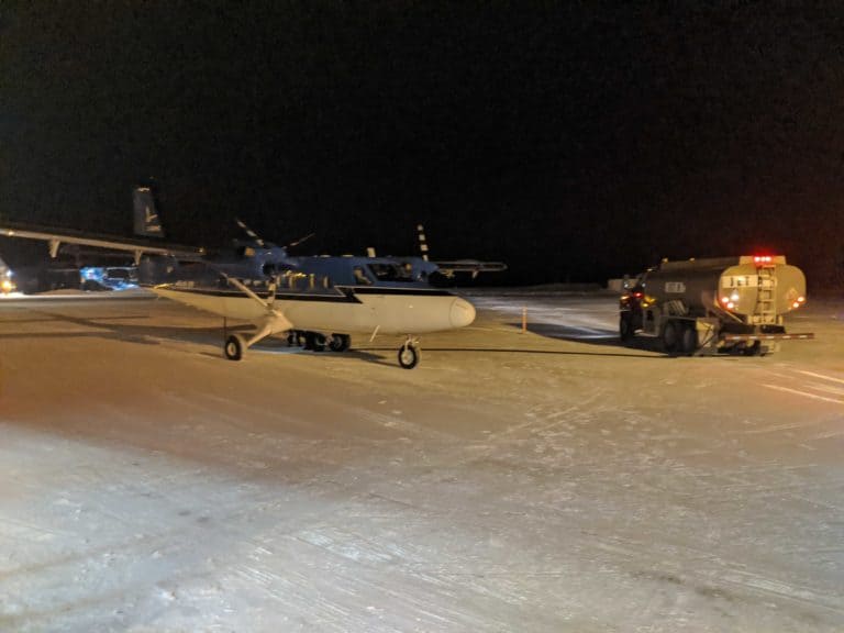 plans and a truck at the airport in grise fiord
