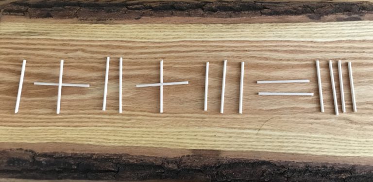 A stick puzzle laying on a wood table.