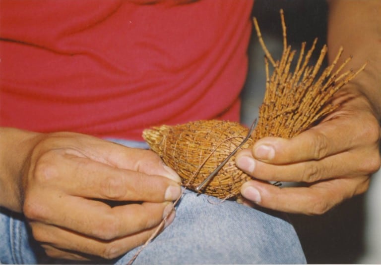 A man working with roots.