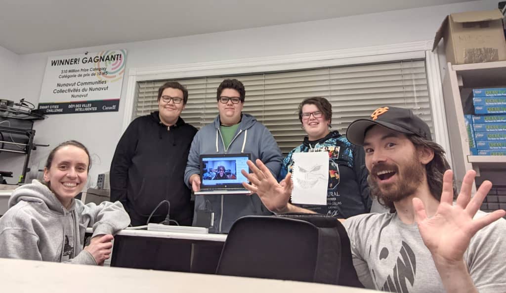 Nunavut Game Jam. 5 people are shown, 3 in the back and one on the left and right hand side.