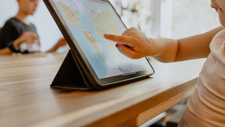 A learner playing a game on a tablet.