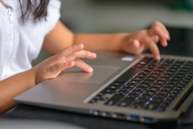 A student typing on a keyboard.