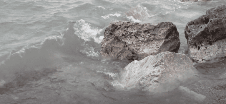 Rocks with water splashing up onto them.