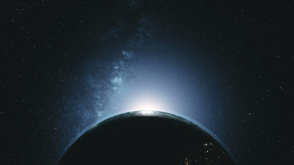 Earth rotating in space, majestic light shining from behind
