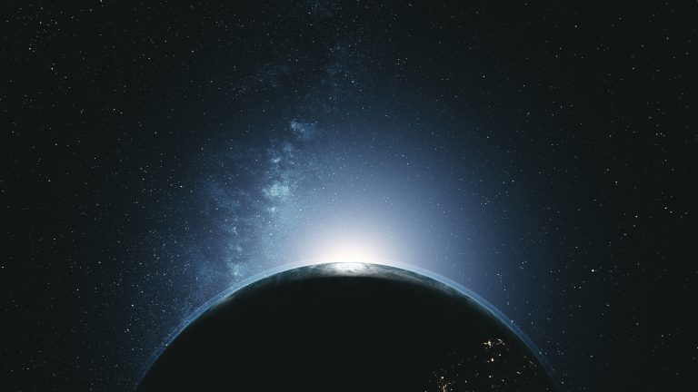 Earth rotating in space, majestic light shining from behind