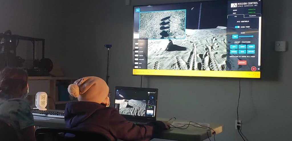 Students learning how to operate a rover on Mars during a production demonstration from a MCSS-Pinnguaq collaboration