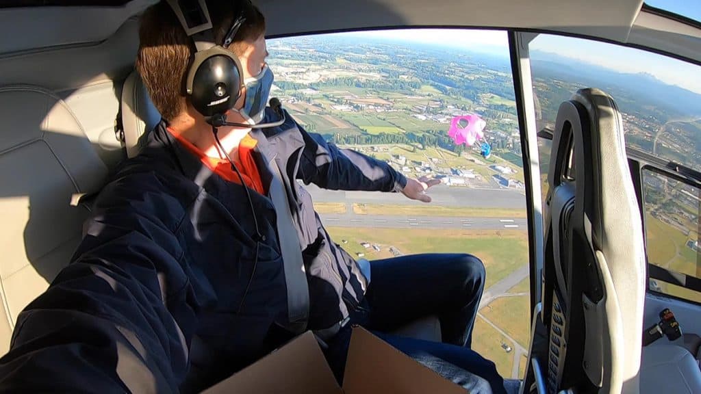 CanSat Design Challenge organiser Lawrence Reeves deploys a CanSat from a helicopter