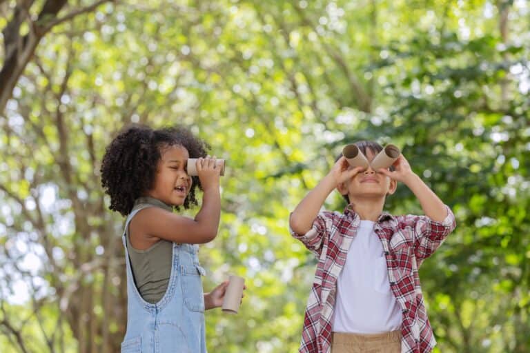 Two children looking at trees.